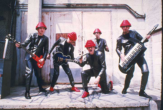 (L to R) Jerry Casale with custom-made bass with Gibson EB-3 neck, Bob1 with Ibanez cloud guitar, 1980