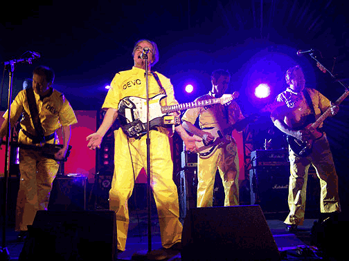 (L to R) Jerry Casale with Steinberger L2, Mark Mothersbaugh with left-handed Fender Stratocaster & duct taped pedals, Bob1 with G&L SC-2, Bob2 with Ibanez Talman TC420