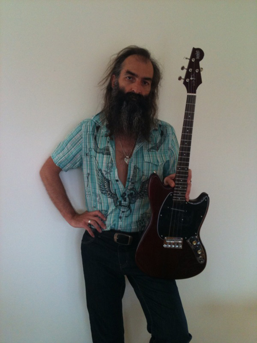 Warren Ellis with his signature Eastwood Tenor Guitar (Cherry Finish)